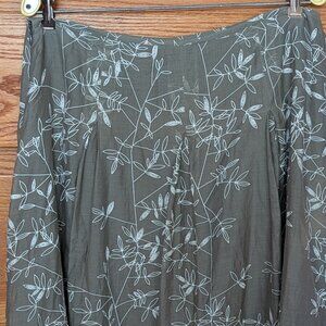 Calvin Klein lined silk skirt size12 with white design on sage green ground.